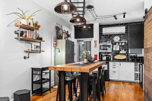 a kitchen with a wooden table and black and white appliances at Industrial Central Apartment - Shop 8 in Fremantle