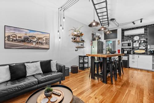 a living room and kitchen with a couch and a table at Industrial Central Apartment - Shop 8 in Fremantle