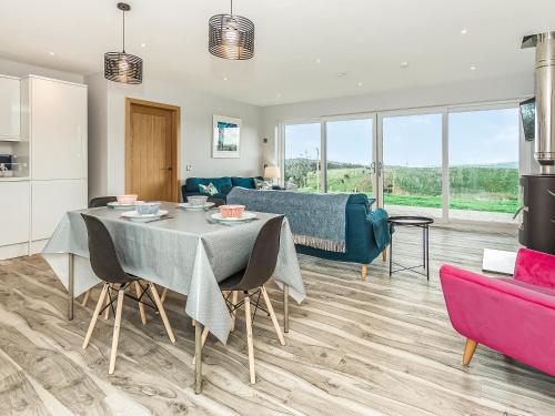 a living room with a table and a couch at High Tide - Uk44283 in Gatehouse of Fleet