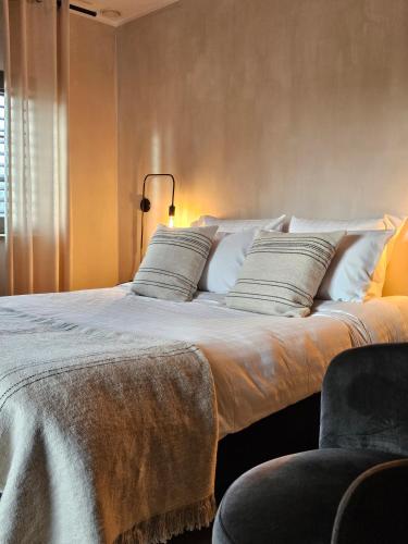 a bedroom with a large bed with white pillows at LA BELLE IDEE in Nokere