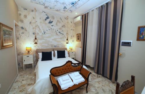 a bedroom with a bed and a chair in it at B&B Villa Mamma Rita in Tortora