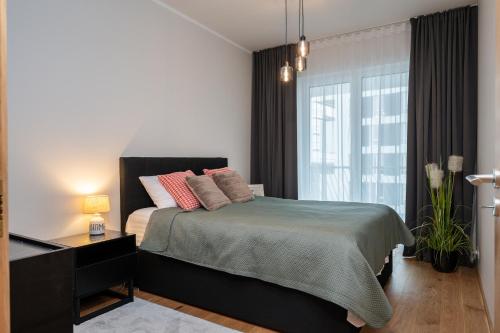 a bedroom with a bed and a large window at Cosy River Suite in Tartu
