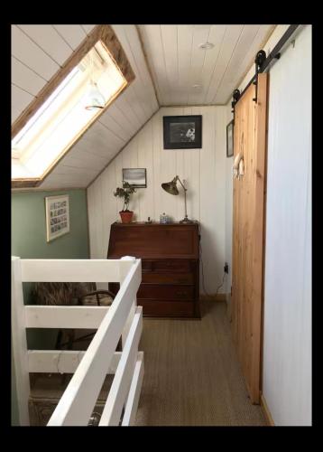 a room with a bed and a desk and a window at Fisherman's Cottage in Orkney