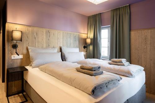 a bedroom with two beds with towels on them at Ranunkelhof in Pirna