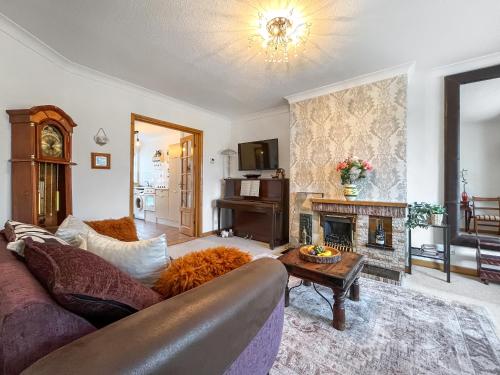 a living room with a couch and a fireplace at Roselynne in Redcar