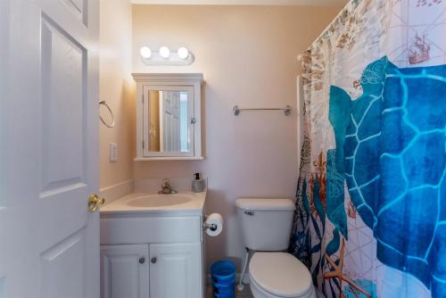 a bathroom with a toilet and a sink at 235 E Spicer Ave, Unit A in Wildwood