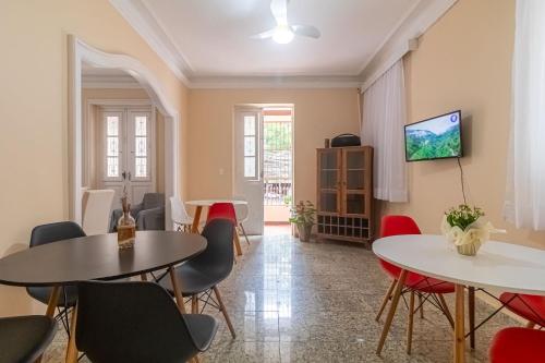 a living room with two tables and chairs at Maroca RIO in Rio de Janeiro