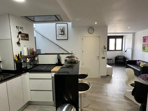 a kitchen with a counter and a living room at Edificio Resort Gran8Nerja in Nerja