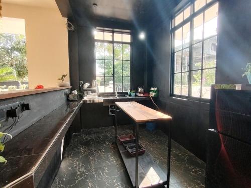 a kitchen with a wooden table in a room at One Love in Weligama