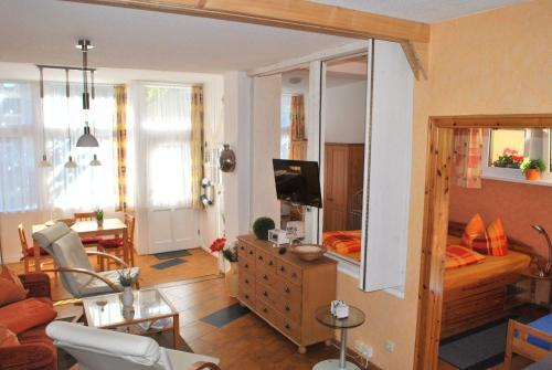 a living room with a couch and a living room with at Ferienwohnung Warnemünde Altstadt (RC) in Warnemünde