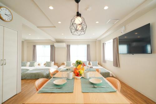a dining room with a table and a couch at Unite Stay Urayasu201 Close to Disneyland, 15 minutes by bus, 8 minutes by car, and good access from the nearest station to Tokyo Station, Ginza, and Asakusa in Tokyo