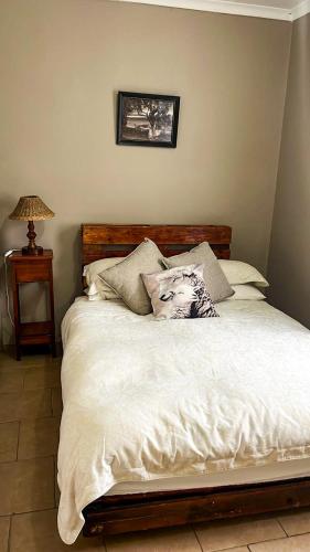 a bed with white sheets and pillows in a bedroom at Lynthorn Farm Cottage in Frere