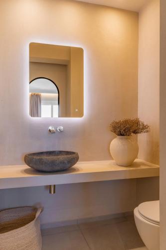a bathroom with a sink and a mirror at Atlantic Island Suites in Astypalaia