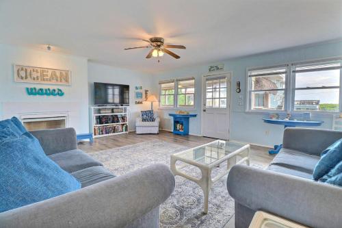 a living room with two couches and a table at 4140 - Beach Carousel in Kitty Hawk