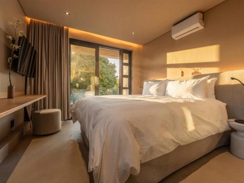 En eller flere senge i et værelse på Guesthouse Ubuntu - Stellenbosch