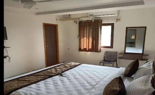 Ένα ή περισσότερα κρεβάτια σε δωμάτιο στο Sri Saai Surguru Residency