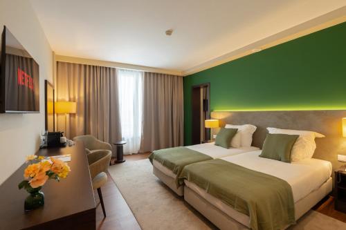 Postel nebo postele na pokoji v ubytování Hotel Premium Porto Maia