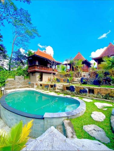 a swimming pool in the yard of a house at Chaplet House 2 in Ubud