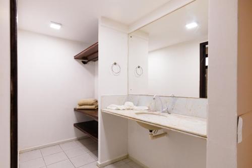a bathroom with a sink and a mirror at Sirius Beach Hotel in Natal