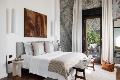 a bedroom with a bed with a white bedspread at Pereh Mountain Resort in Gadot