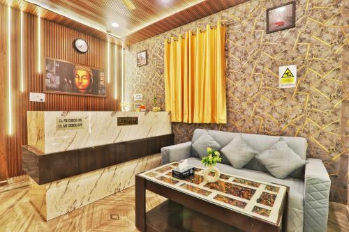 a living room with a couch and a table at Hotel Kasol Heritage in Lucknow
