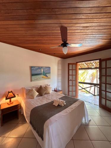 a bedroom with a bed with a ceiling fan at Pousada Recanto da Serra in Serra do Cipo