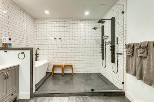 a bathroom with a shower and two orange stools at 2 Mi to Dtwn Jax Game-Ready Retreat with Yard in Springfield