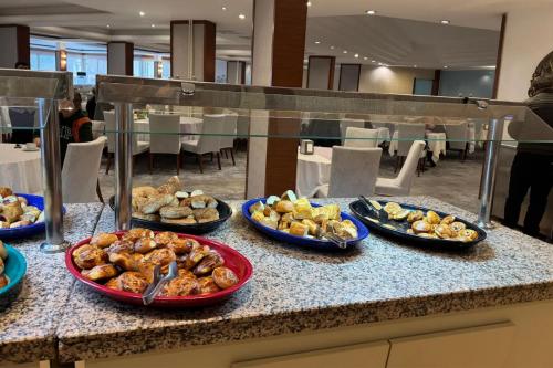 a buffet with plates of food on a counter at Lycus River Thermal Hotel in Pamukkale