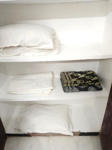 a bunk bed with two pillows and a towel at Chan Maison @ Lakshmi Gardens in Pondicherry