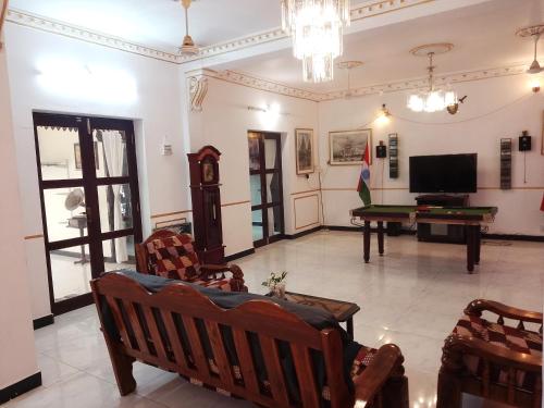 a living room with a tv and a pool table at Chan Maison @ Lakshmi Gardens in Puducherry