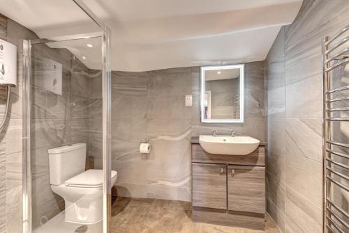 a bathroom with a toilet and a sink at 2 Bed in Elterwater oc-gl004 in Chapel Stile
