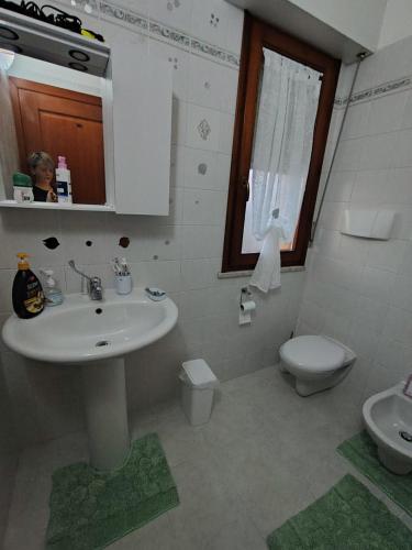 a bathroom with a sink and a toilet at "Da Carla e Sandro" in Quartucciu