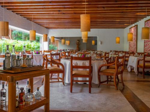 a dining room with tables and chairs in a restaurant at Las Brisas Ixtapa in Ixtapa