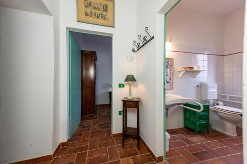 a bathroom with a toilet and a sink at Il Borgo Del Lupo Relax Family Apartments in Tuscany with Restaurant & Swimming Pool in Sarteano