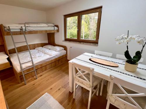 a room with a desk and a bunk bed at Sunflower in Kranjska Gora