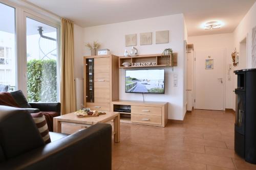 a living room with a tv and a couch at Seedüne 1 in Großenbrode