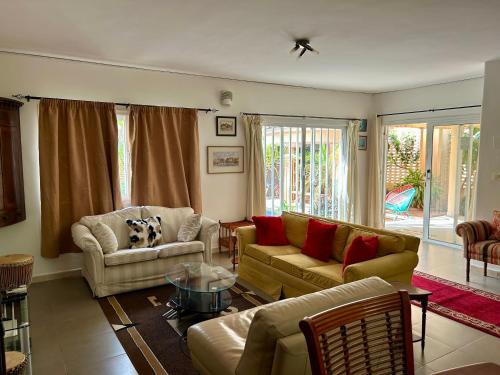 a living room with two couches and a table at Two bedroom villa with private swimming pool and garden in Almadies in Dakar