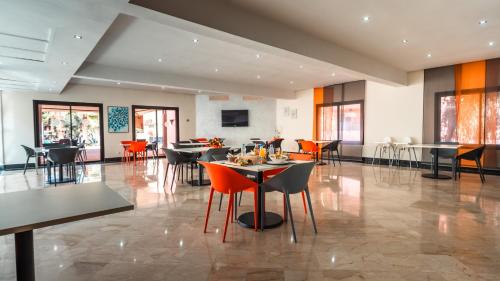 a dining room with tables and chairs in a building at Oliva Hotel Condominium Marrakech in Marrakech