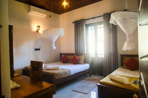 Postel nebo postele na pokoji v ubytování Casa De Chica Mirissa