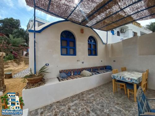 a patio with a couch and a table at Nubian Lotus in Aswan