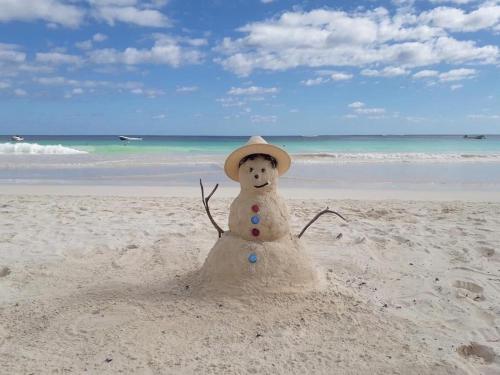 a snowman made out of sand on a beach at Casa LaMar 10 min Beach WIFI 300 MB2Gyms6Pools in Playa del Carmen