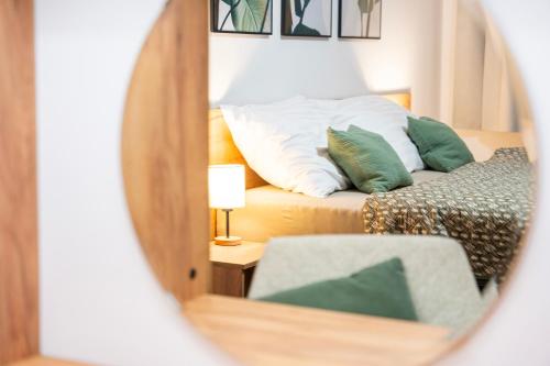 a mirror reflection of a bed in a bedroom at Lipno Stories in Lipno nad Vltavou