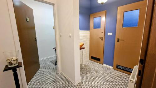 a bathroom with two doors and a toilet at Orientarium Atlas Arena Family House in Łódź