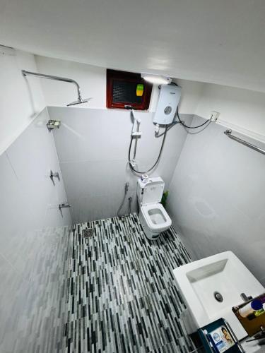 a small bathroom with a toilet and a sink at Browns Hill Matara in Matara