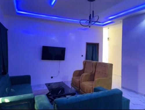 a living room with two couches and a tv at Superetoile in Rufisque