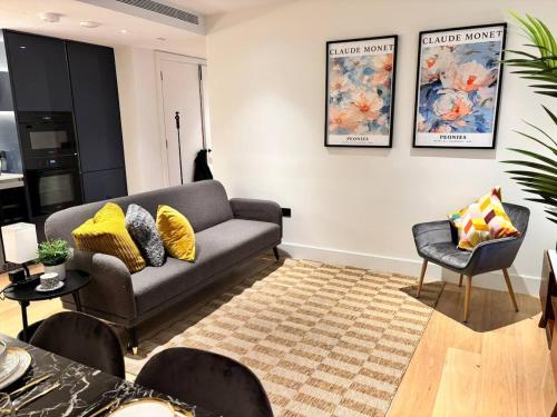 a living room with a couch and a chair at Luxury 2BR- Sleeps 5- Westfield Apartment- 3 min to station- Perfect for Families Shopping in London