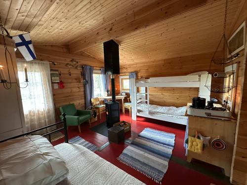 a room with a bedroom with a bed and a desk at Forestry cabin and sauna cabin in Halmevaara