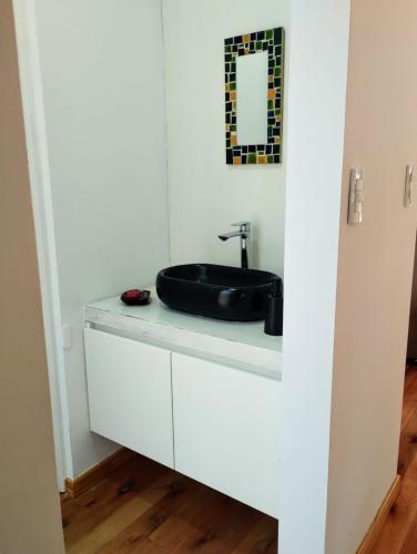 a bathroom with a sink on a white cabinet at Big Sur in Mar Azul