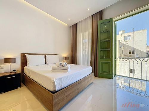 a bedroom with a bed and a large window at Malta Rooftop Villa with Private Plunge Pool & BBQ in Hal Ghaxiak