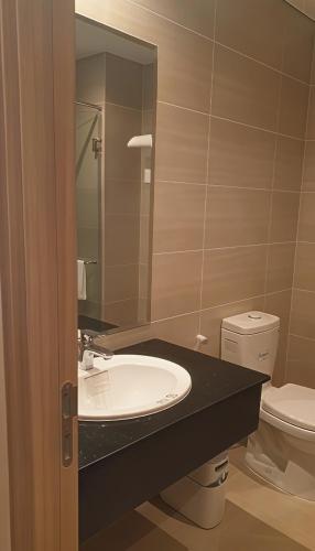 a bathroom with a sink and a toilet at HADU Hotel & Café Phu Quoc in Phú Quốc